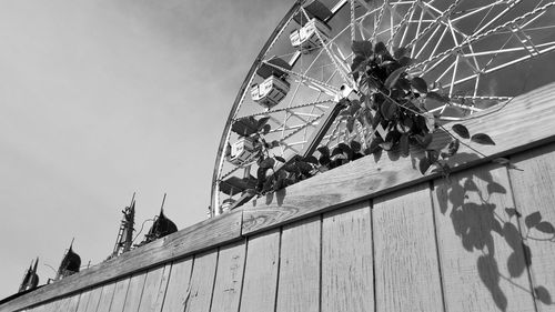 Low angle view of ferris wheel against building