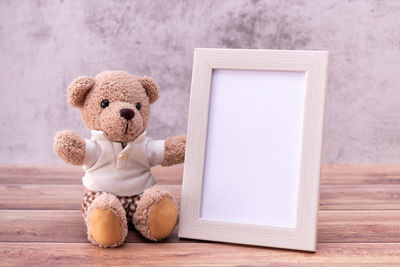 Close-up of stuffed toy on table against wall