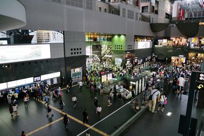 High angle view of people walking on road in city