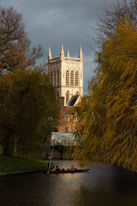 Building by river against sky