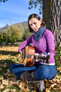 Man playing guitar on field