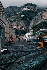 People on street amidst buildings in city