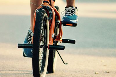 Low section view of person riding bicycle