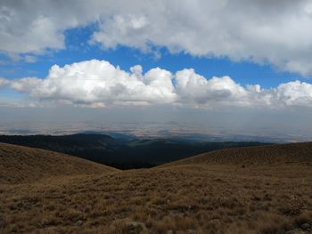 Scenic view of arid landscape against sky