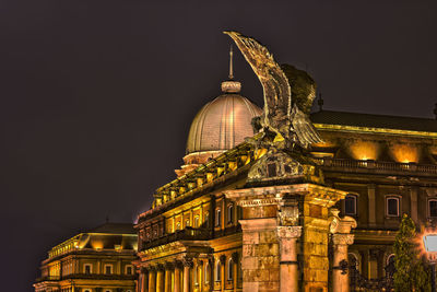 Low angle view of illuminated tower at night