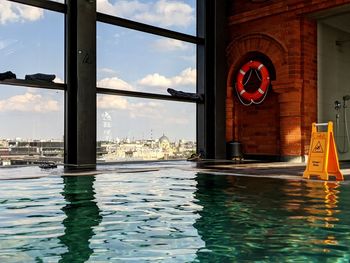 View of swimming pool by building against sky