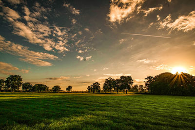 Scenic view of field against sky during sunset