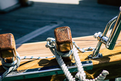 Close-up of ropes tied on wood