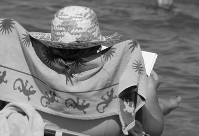 High angle portrait of woman sitting by lake