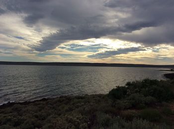 Scenic view of landscape against dramatic sky