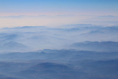 Scenic view of mountains in foggy weather