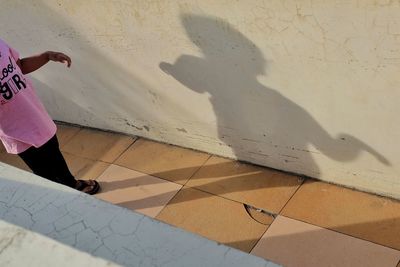 Low section of woman walking on tiled floor