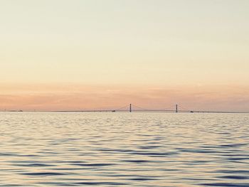 Sailboat sailing on sea against sky during sunset