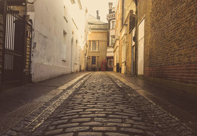 Alley amidst building in city