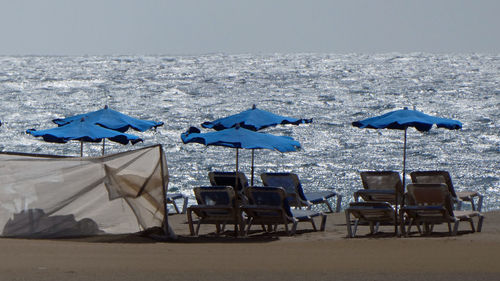 Scenic beach chairs and parasols against sea and blue sky in lanzarote 