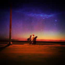 Scenic view of landscape against sky at night