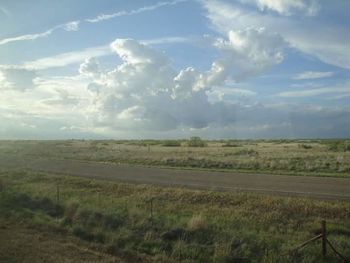 Scenic view of landscape against cloudy sky