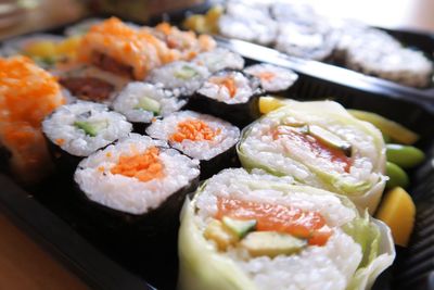 Close-up of sushi served with beans in tray
