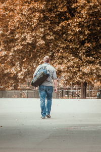 Rear view of man standing on road