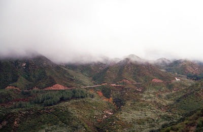 Scenic view of mountains against clouds