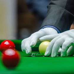 Cropped hands placing balls on pool table