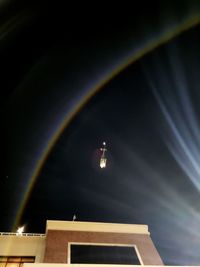 Low angle view of illuminated building against sky at night