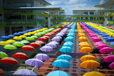 Multi colored umbrellas against sky