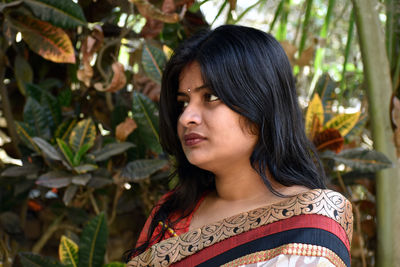 Portrait of young woman looking away