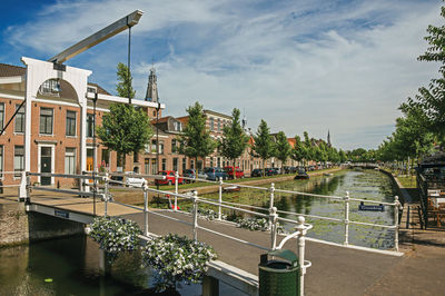 Bascule bridge over water canal and brick houses in weesp. a pleasant small village in netherlands.