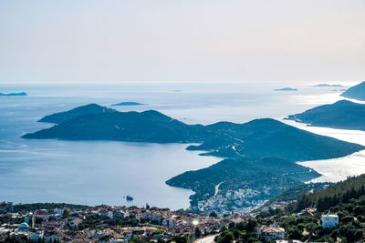 High angle view of townscape by sea against sky