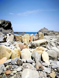 Rocks on beach against sky