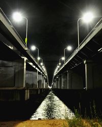 Illuminated railroad tracks at night