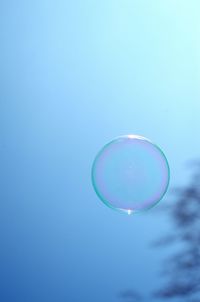 Close-up of bubbles against blue sky