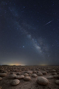 Scenic view of rocks against sky at night