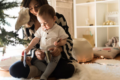 Mother and daughter sitting on floor