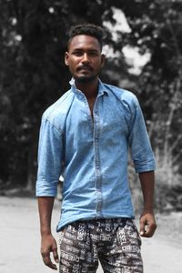 Portrait of young man standing outdoors