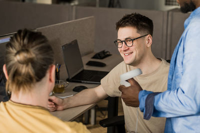 It development team working on vr project. man wearing vr headset, playing 