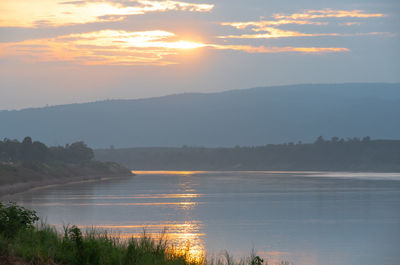 Scenic view of lake against sky during sunset