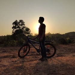 Man riding bicycle on field