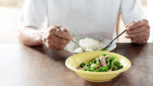 Midsection of man preparing food