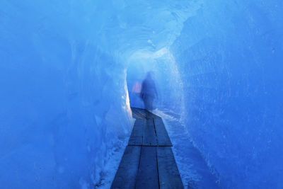 Person in blue tunnel
