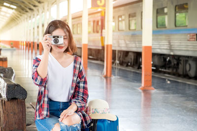 Portrait of woman sitting on train
