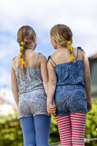 Girls with dandelion flower in braid