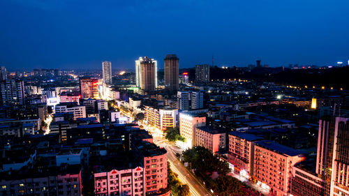 Aerial view of city lit up at night