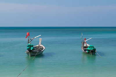 Motor boat in sea against sky