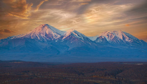 The sunset at avachinsky and kozelsky volcano on the kamchatka peninsula