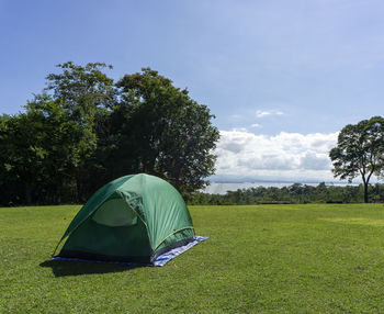 Tent in field against sky