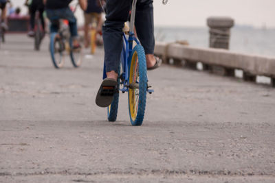 Low section of man cycling on promenade