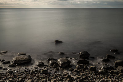 High angle view of rocks by sea against sky