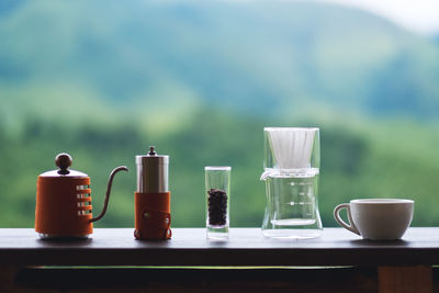 A set of coffee drip equipment with blurred nature background